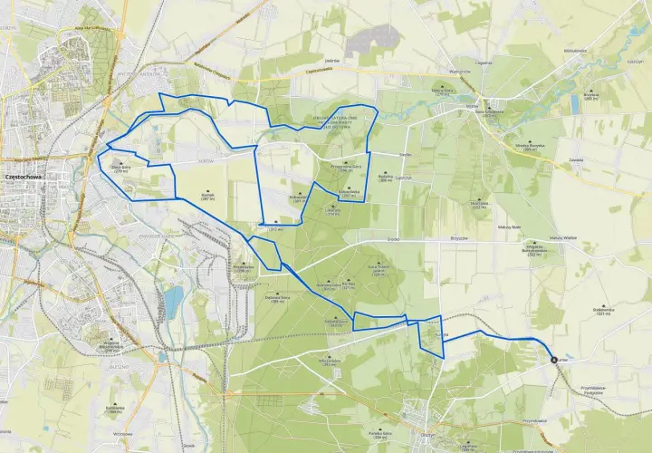 Mapa z zaznaczonymi trasami rowerowymi wokół Olsztyna. Szlak prowadzi przez tereny zielone, w pobliżu wzgórz i lasów.
