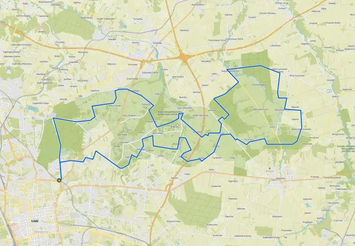 Mapa z zaznaczoną trasą rowerową wokół Łodzi, przechodzącą przez tereny zielone i miejscowości.