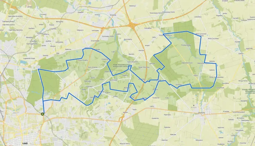 Mapa z zaznaczoną trasą rowerową wokół Łodzi, przechodzącą przez tereny zielone i miejscowości.