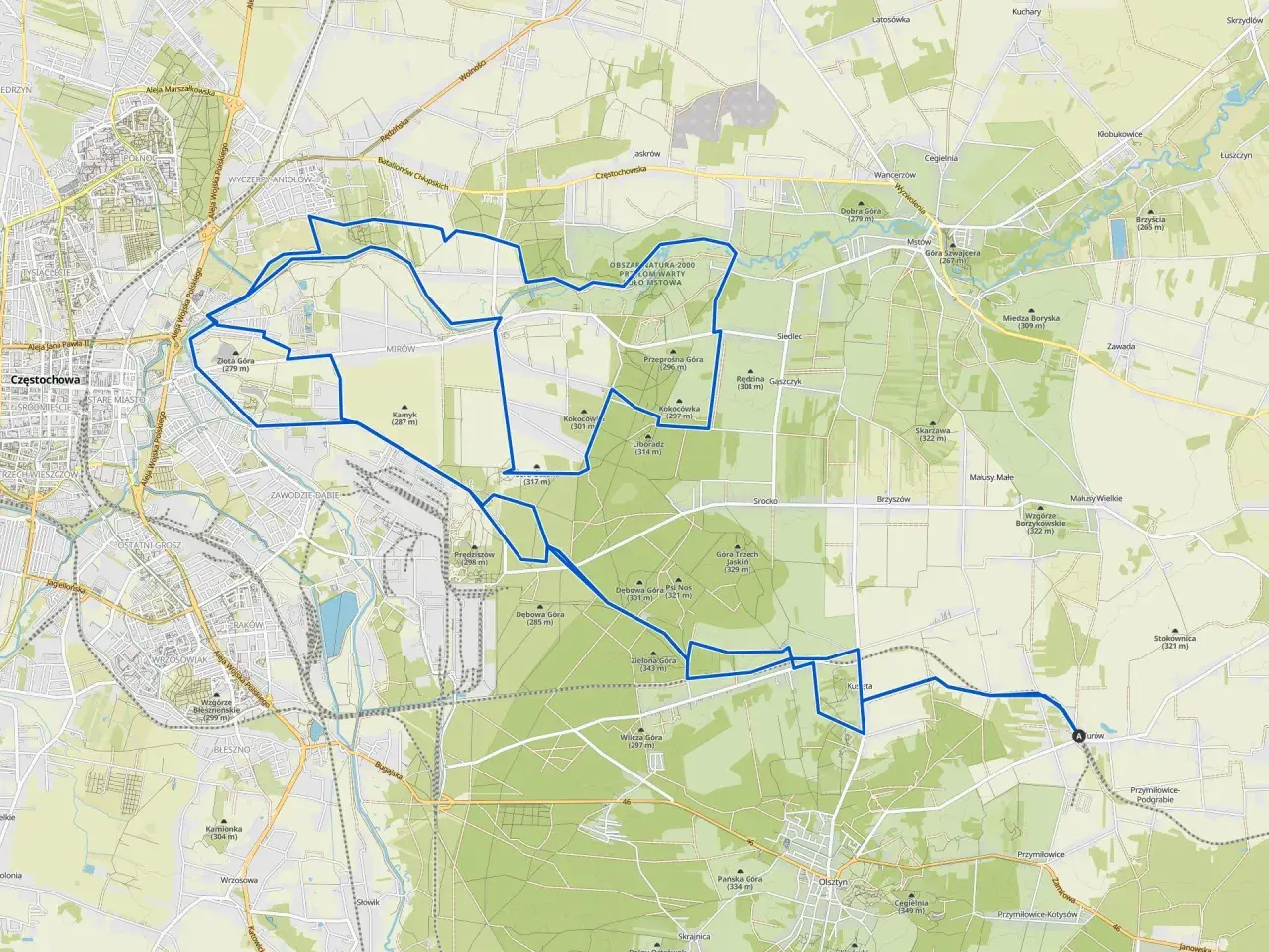 Mapa z zaznaczonymi trasami rowerowymi wokół Olsztyna. Szlak prowadzi przez tereny zielone, w pobliżu wzgórz i lasów.