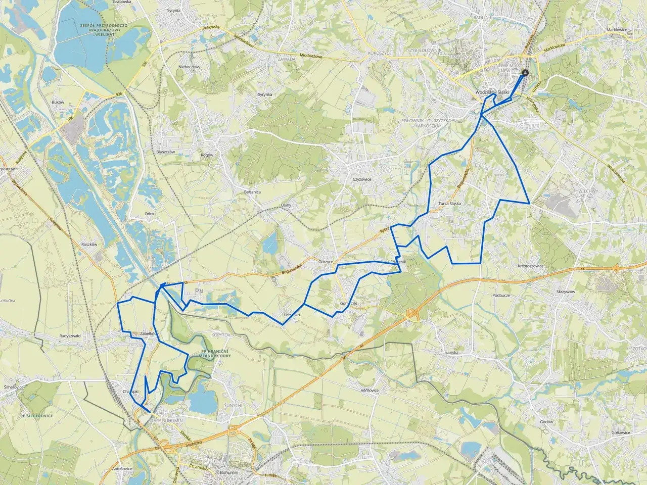 Mapa z zaznaczoną trasą rowerową wokół Wodzisławia Śląskiego, prowadzącą przez tereny zielone i w pobliżu zbiorników wodnych.